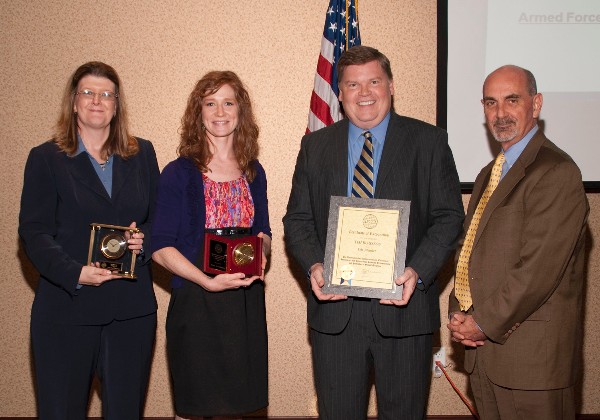 At the May luncheon, Dan Curtis (r), chapter president, recognizes Tim Roussos, an AFCEA life member; Jacqueline D. Murray (l), Electronic Systems Center, U.S. Air Force, recipient of the Distinguished Award for Excellence in Engineering; and Hilary L. Gallagher, Air Force Research Laboratory, recipient of the Meritorious Rising Star Award for Achievement in Engineering.